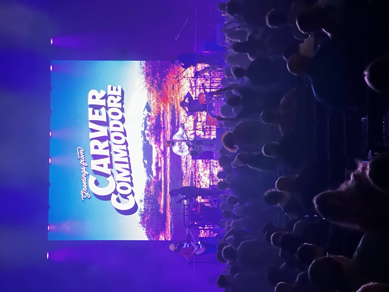 Venue screen displaying the Commodores above a standing crowd